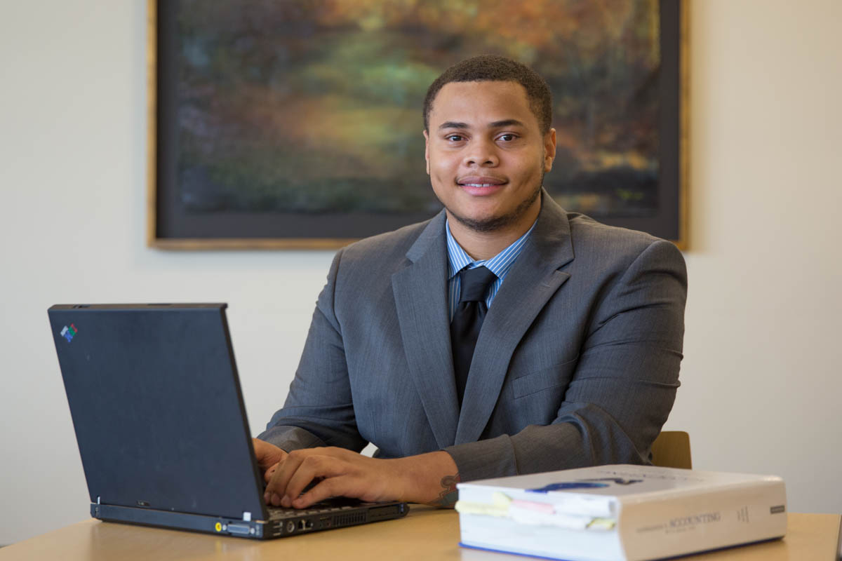 Man in suit working on a laptop